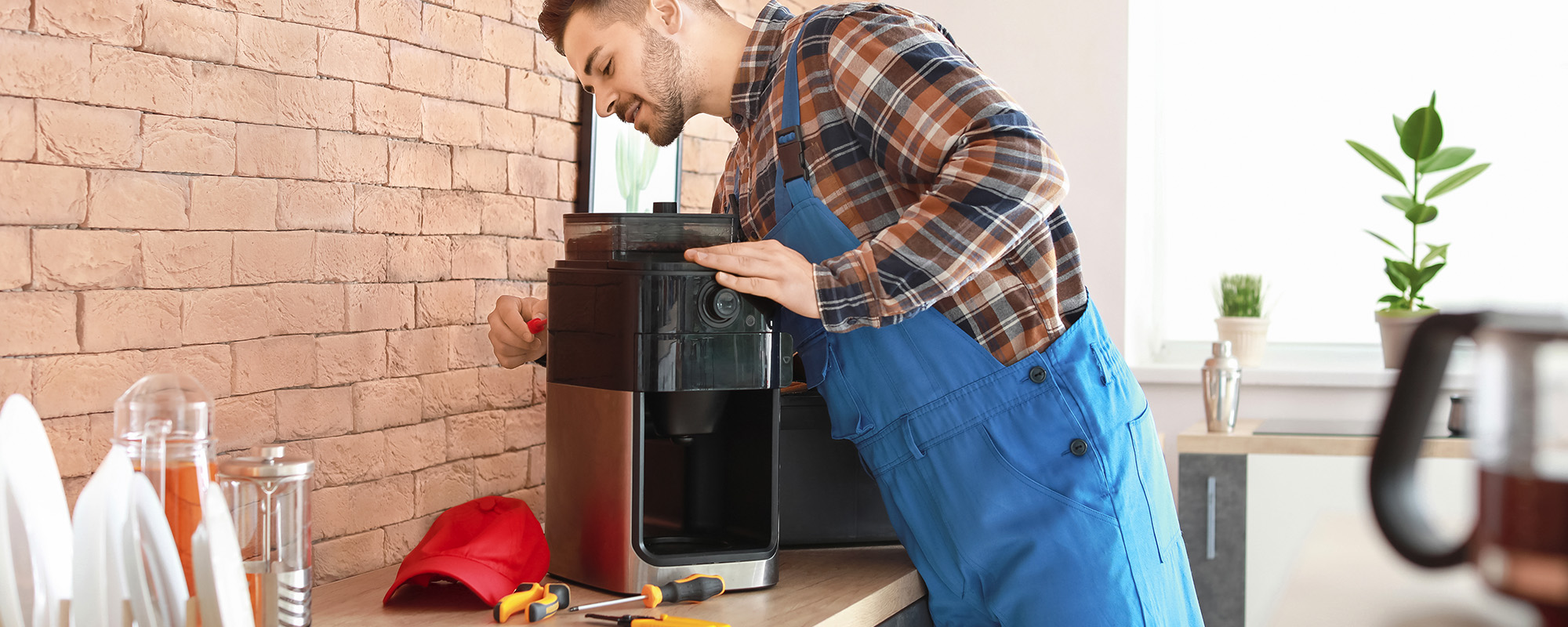 man repairing coffee machine in kitchen