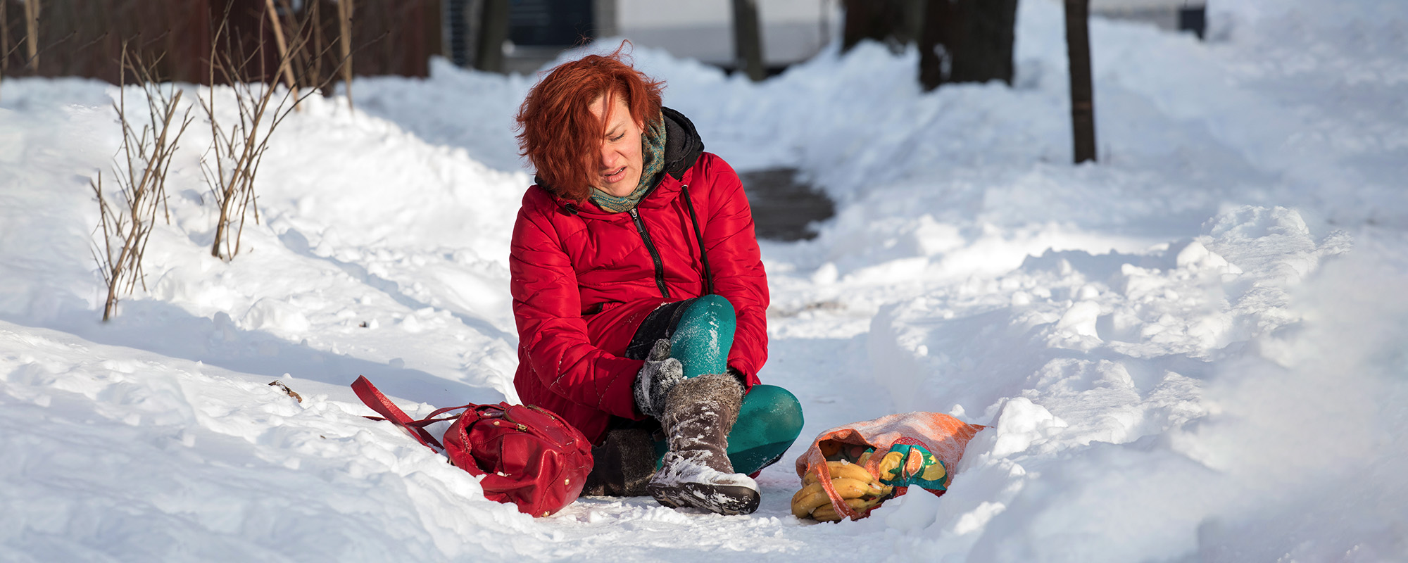 woman injured fall snow sidewalk
