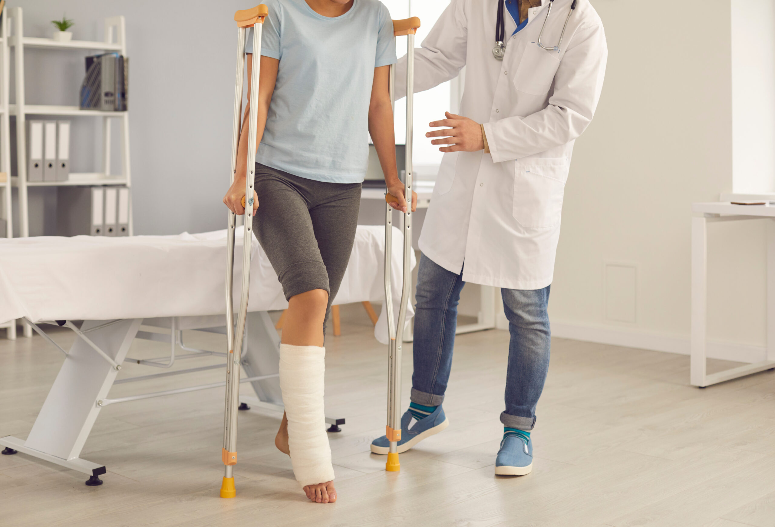 injured person with broke leg and crutches