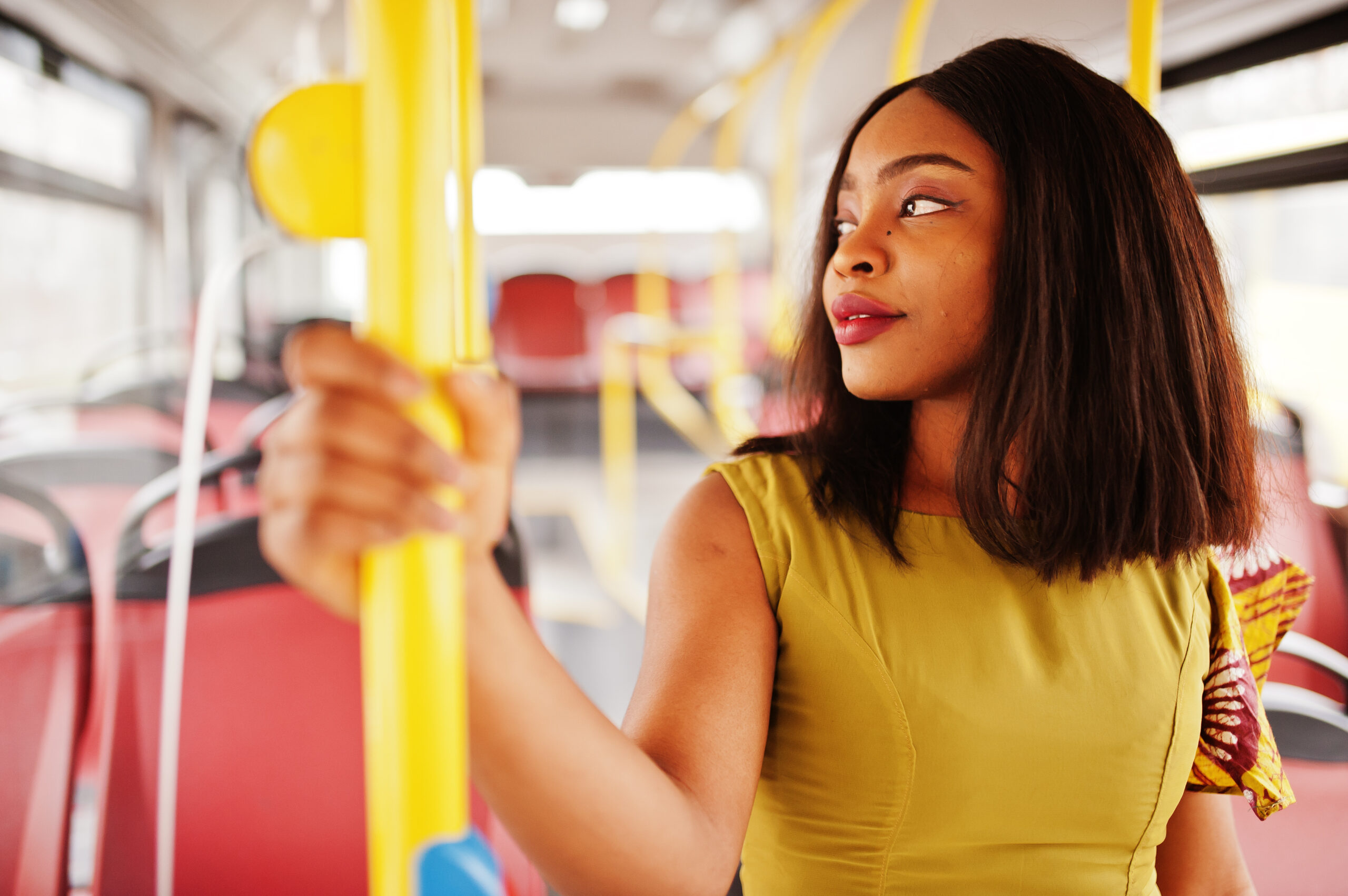 Young stylish woman riding on a bus.
